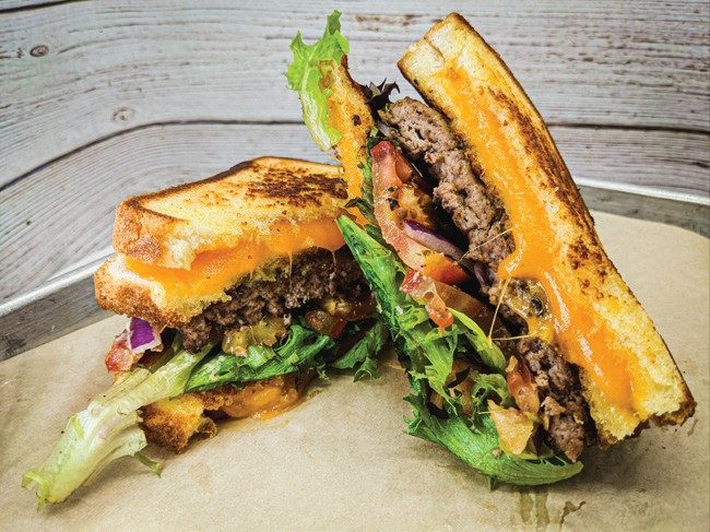 Oh My Burger grilled cheese burger cut in half